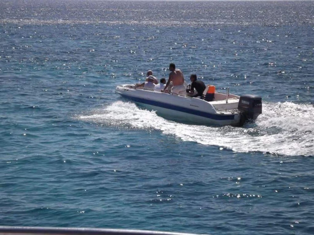 White speedboat with blue stripe